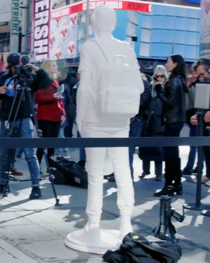 The 3D-printed figure of Joaquin Oliver standing in Times Square as press and passersby gather